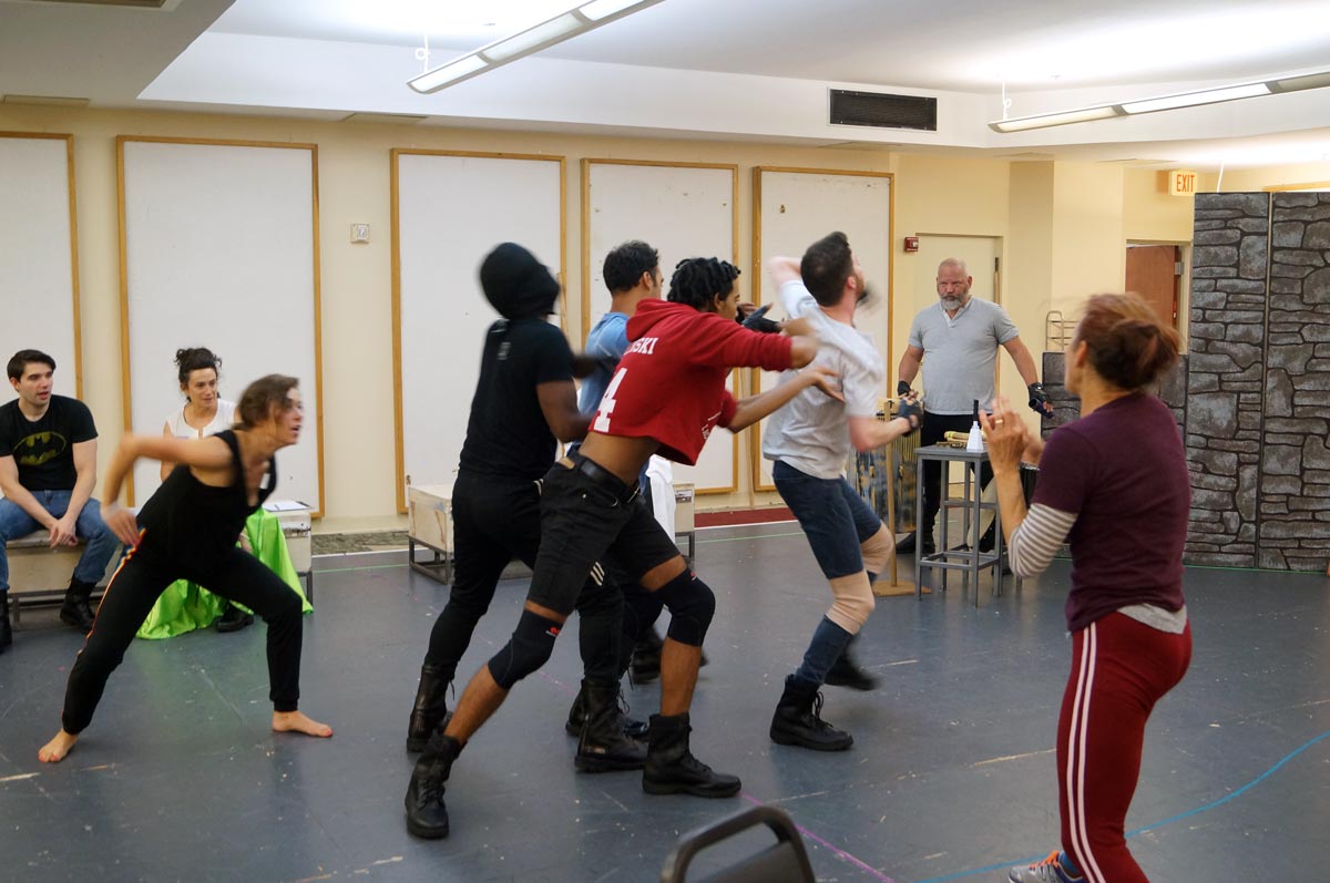 Photo features the cast of Macbeth rehearsing choreography