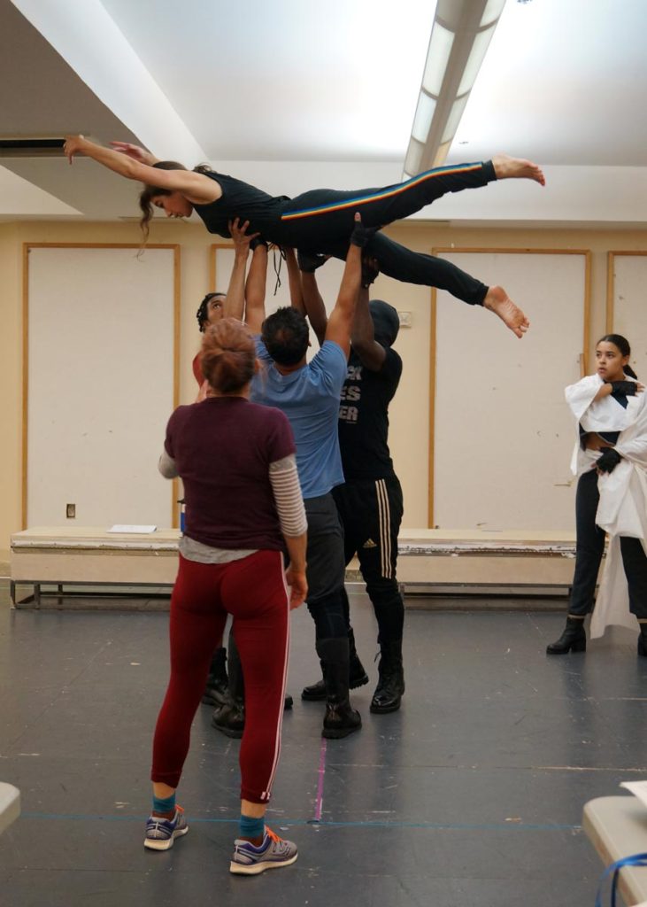 Photo features the cast of Macbeth rehearsing choreography